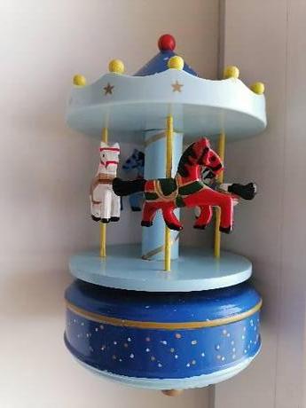 Drevený točiaci kolotoč s koníkmi a hudbou, 
