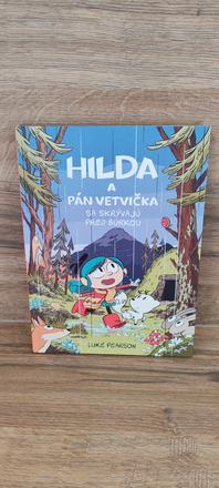 Hilda a pán vetvička sa skrývajú pred búrkou,