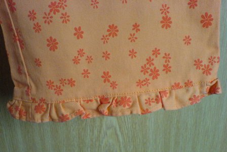 Oranžové capri nohavice s kvietočkami, l